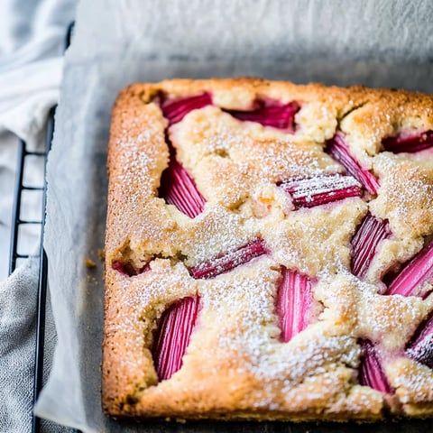A slice of cake with white powdered sugar on top.