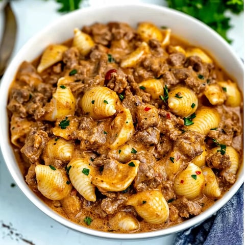 A bowl of pasta with meat sauce.