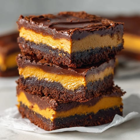 A stack of three chocolate cake bars.