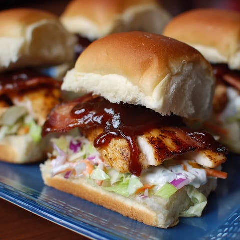 A plate of sandwiches with barbecue sauce.