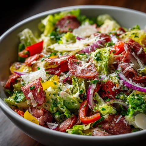A bowl of salad with meat and vegetables.