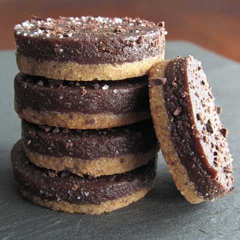 A stack of chocolate cookies with a sprinkle of sugar on top.