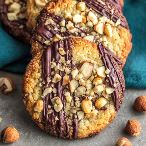 A cookie with chocolate and nuts on top.